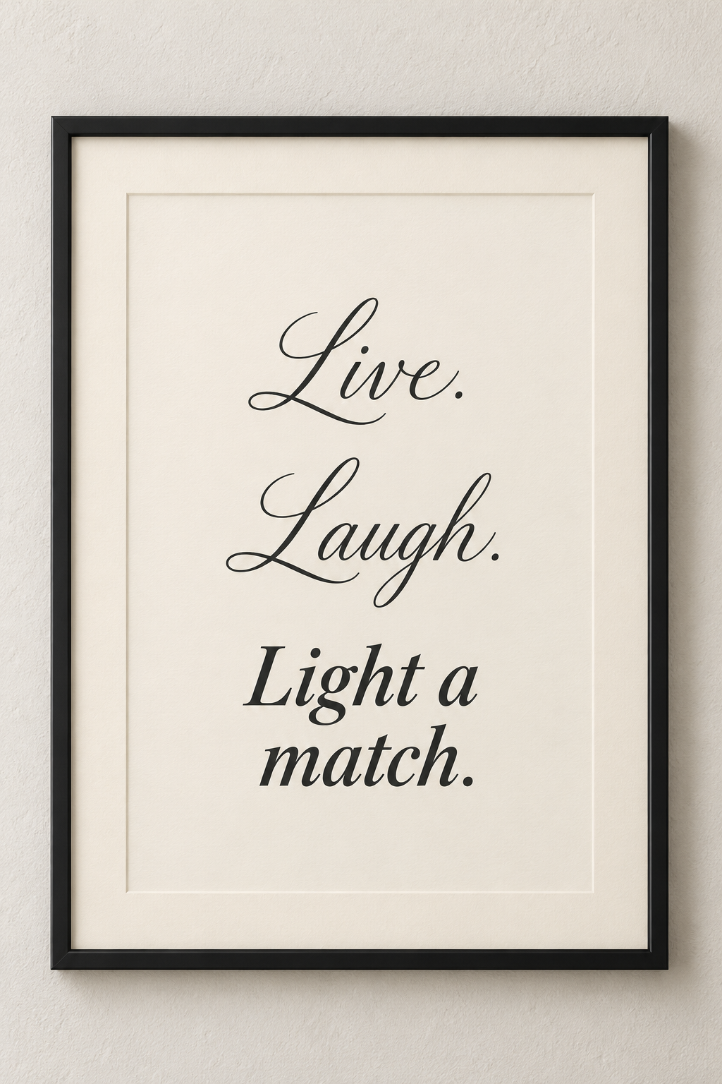 Black-framed ivory bathroom print reading Live. Laugh. Light a match.