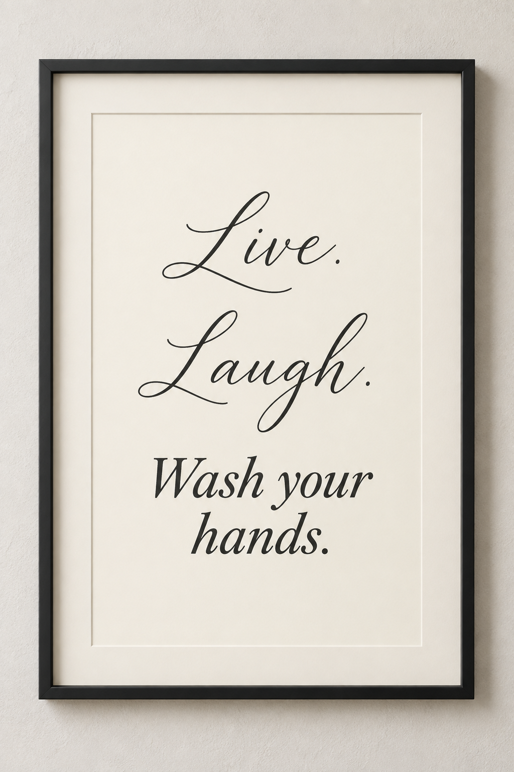 Black-framed ivory bathroom print reading Live. Laugh. Wash your hands.